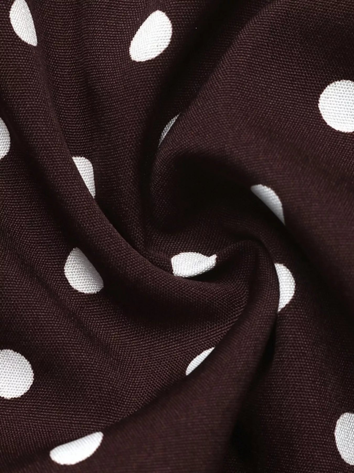 Close-up detail of coffee brown polka dot fabric with white dots