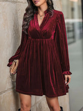 Women's ruched mini dress with a surplice neckline.