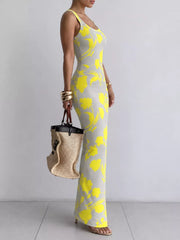 Grey sleeveless bodycon maxi dress with bold yellow floral print in side profile
