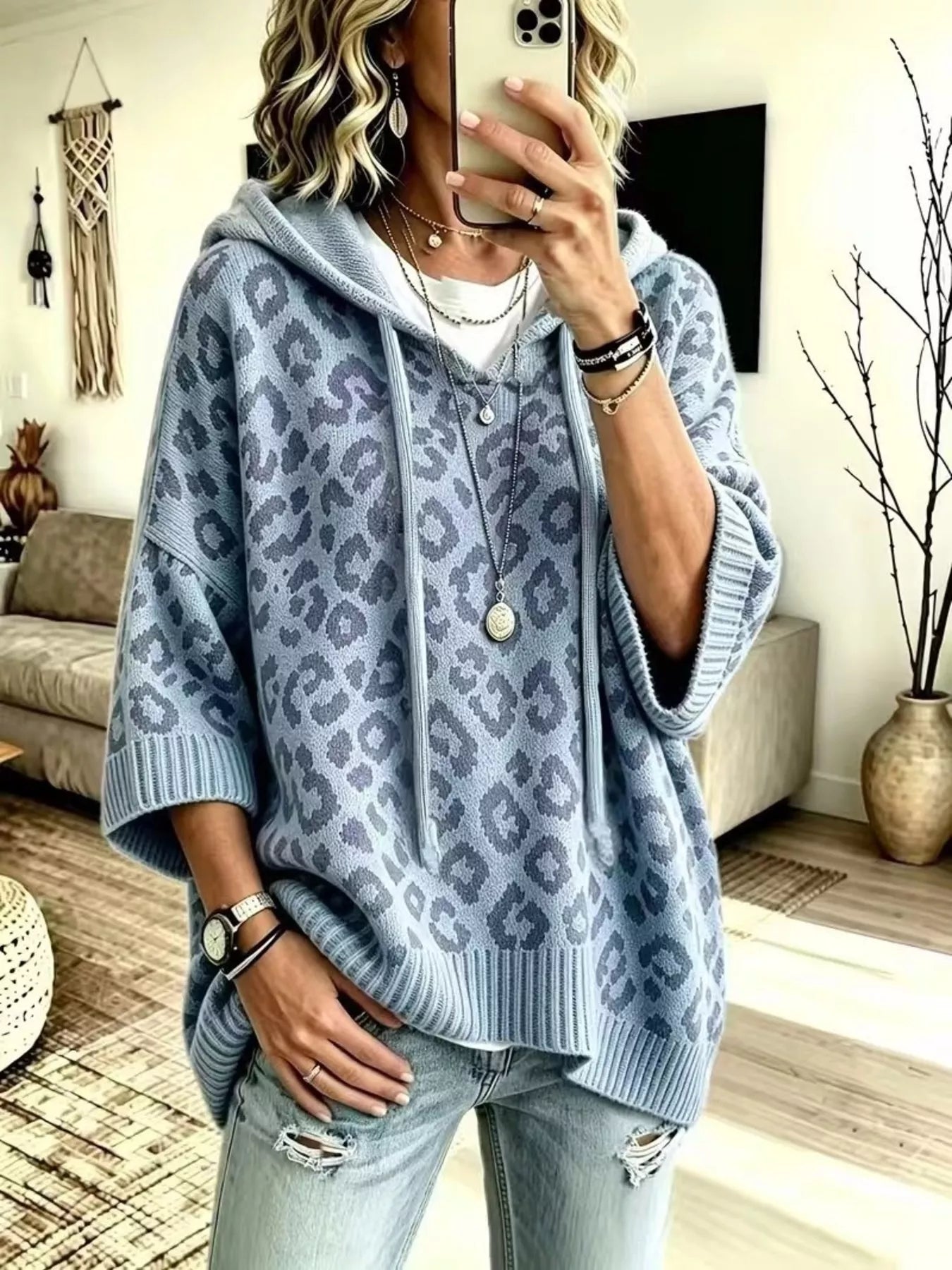 Dusty blue leopard print oversized hooded knit sweater with drawstrings, front view on model