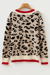 Back view of beige leopard print knit sweater with red and cream trim on a hanger.