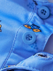 Close view of the polo buttons and small tractor print on the blue children's polo shirt
