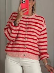 Mirror selfie front view of pink and red striped button down cardigan with white pants