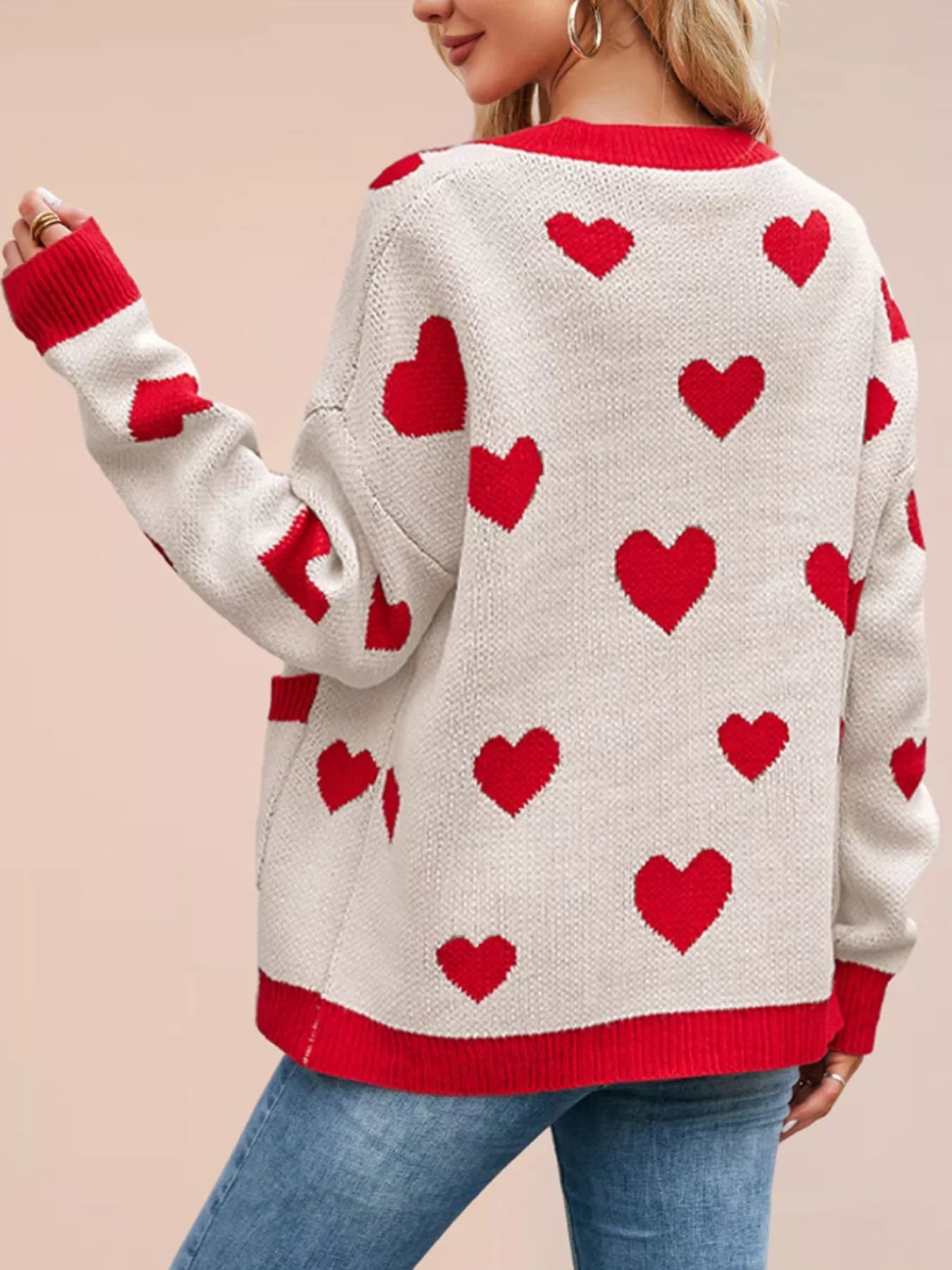 Back view of the cream knit cardigan with red hearts and red trim