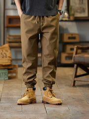 Men's khaki casual joggers with a drawstring waist and pockets.