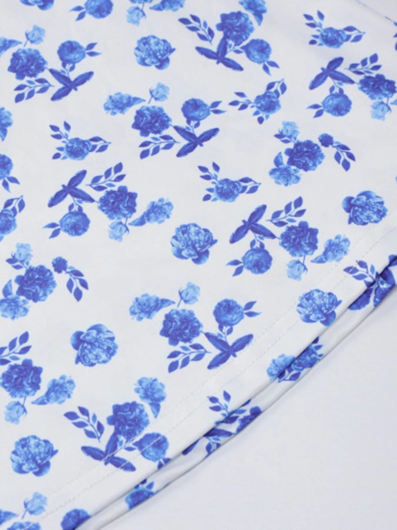 Close up of blue floral print fabric and stitched hem of bodycon maxi dress