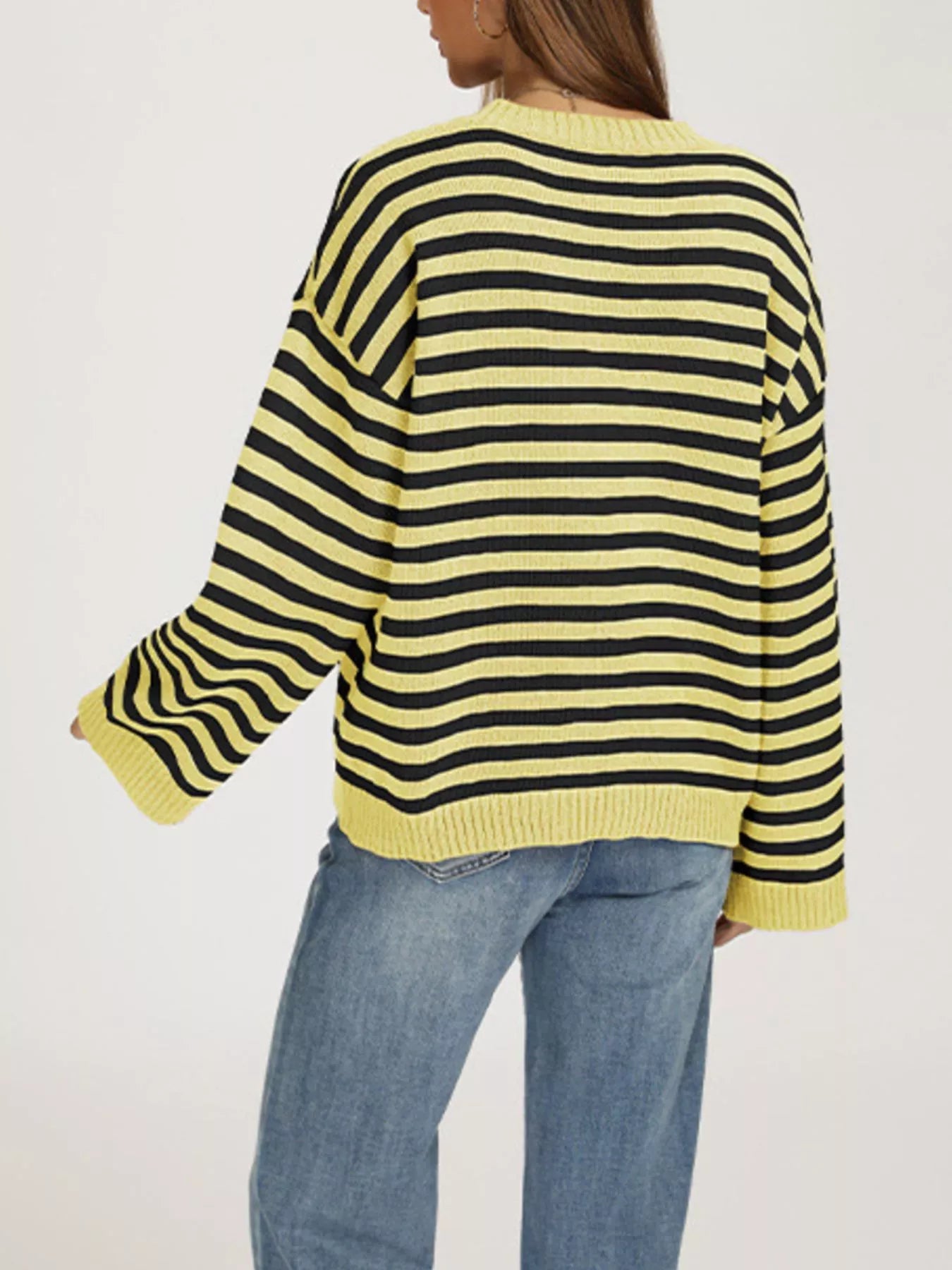 Back view of the yellow and black striped dropped shoulder sweater with ribbed hem and cuffs.
