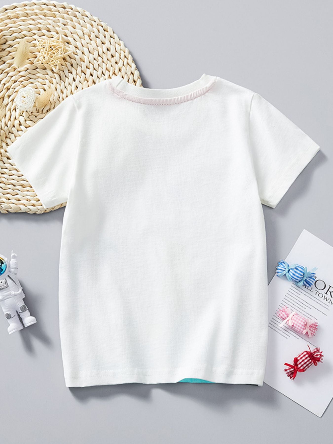 Plain back view of the white children's round neck t-shirt laid flat