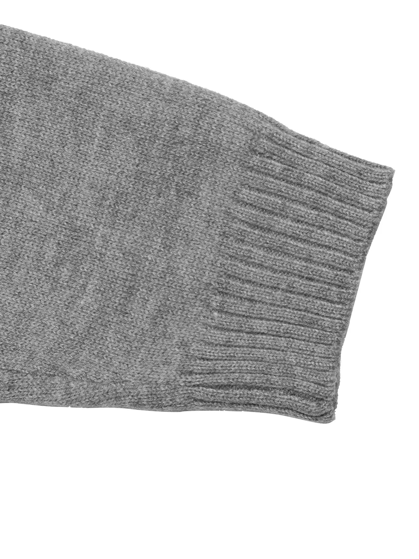 Close up of the gray ribbed sleeve cuff on the dropped shoulder knit sweater
