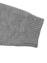 Close up of the gray ribbed sleeve cuff on the dropped shoulder knit sweater