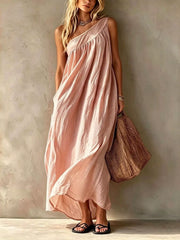 Full length front view of a blush pink one shoulder maxi dress on a model