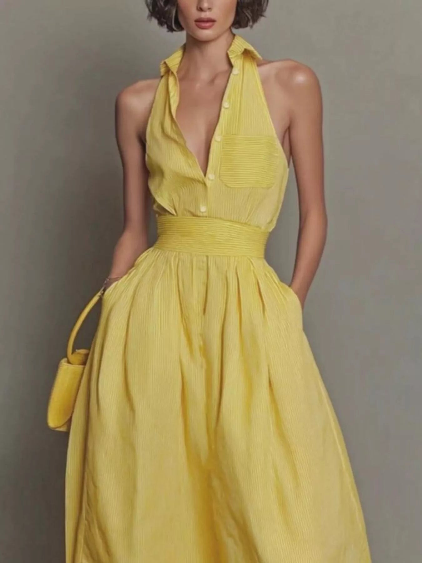 Cropped front view of yellow sleeveless maxi dress showing collar buttons and chest pocket