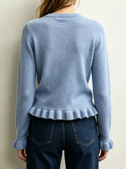 Back view on-model of light blue crew neck sweater with ruffled hem and cuffs