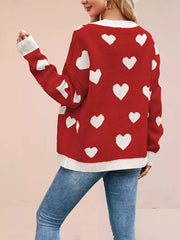 Back view of the red knit cardigan with white hearts and cream trim