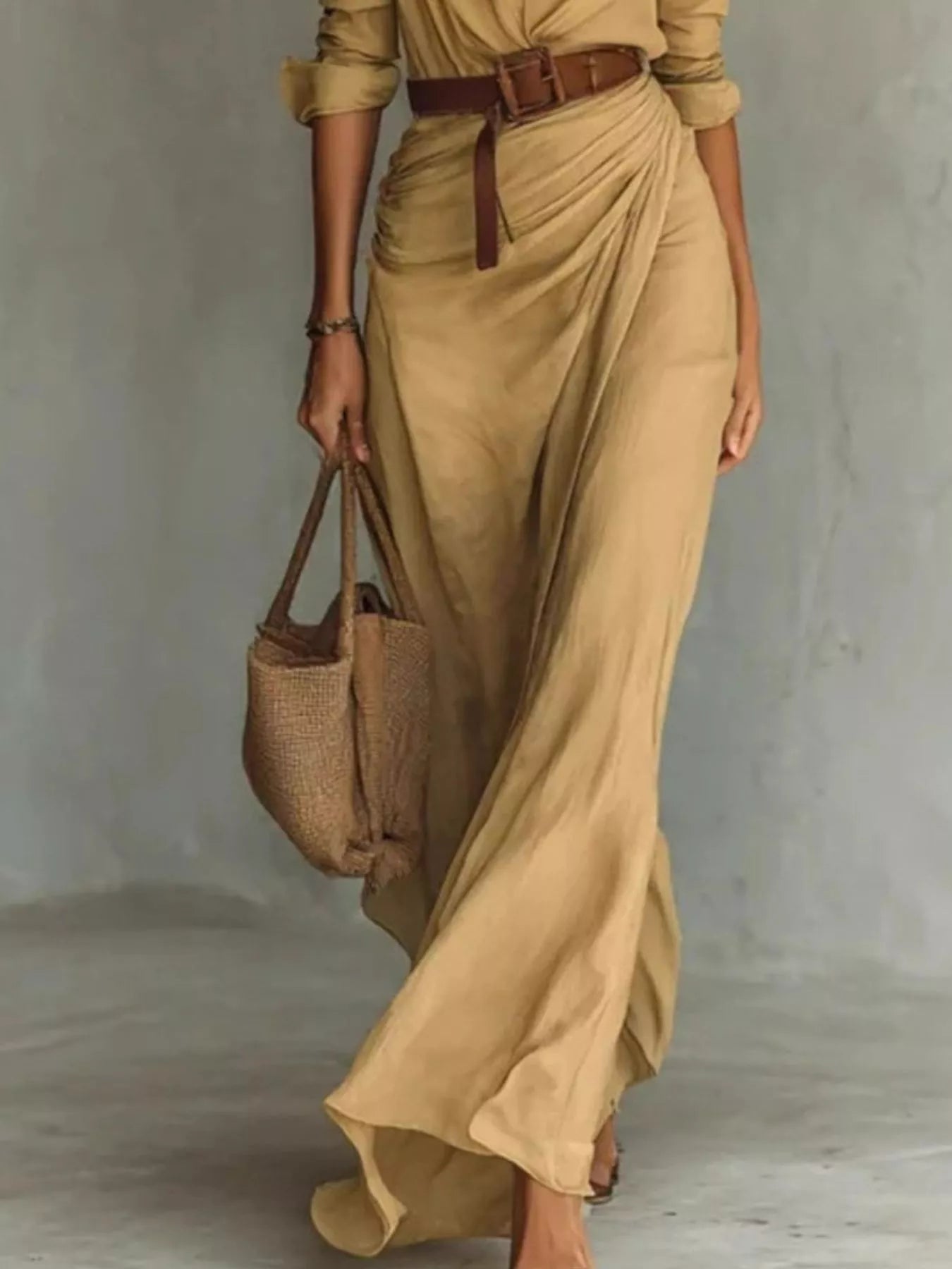 Lower view of a camel shirt maxi dress showing the draped skirt and brown belt detail