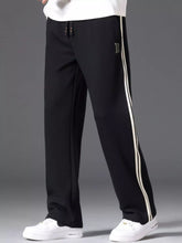 Men's side striped casual pants with a drawstring waist and pockets.