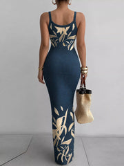 Navy blue sleeveless bodycon maxi dress with cream leaf print viewed from behind