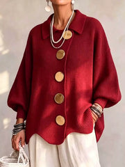 Front view of a deep red knit cardigan with large gold buttons