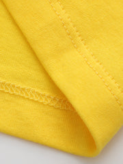 Close-up of yellow children's t-shirt fabric and stitching at the sleeve seam