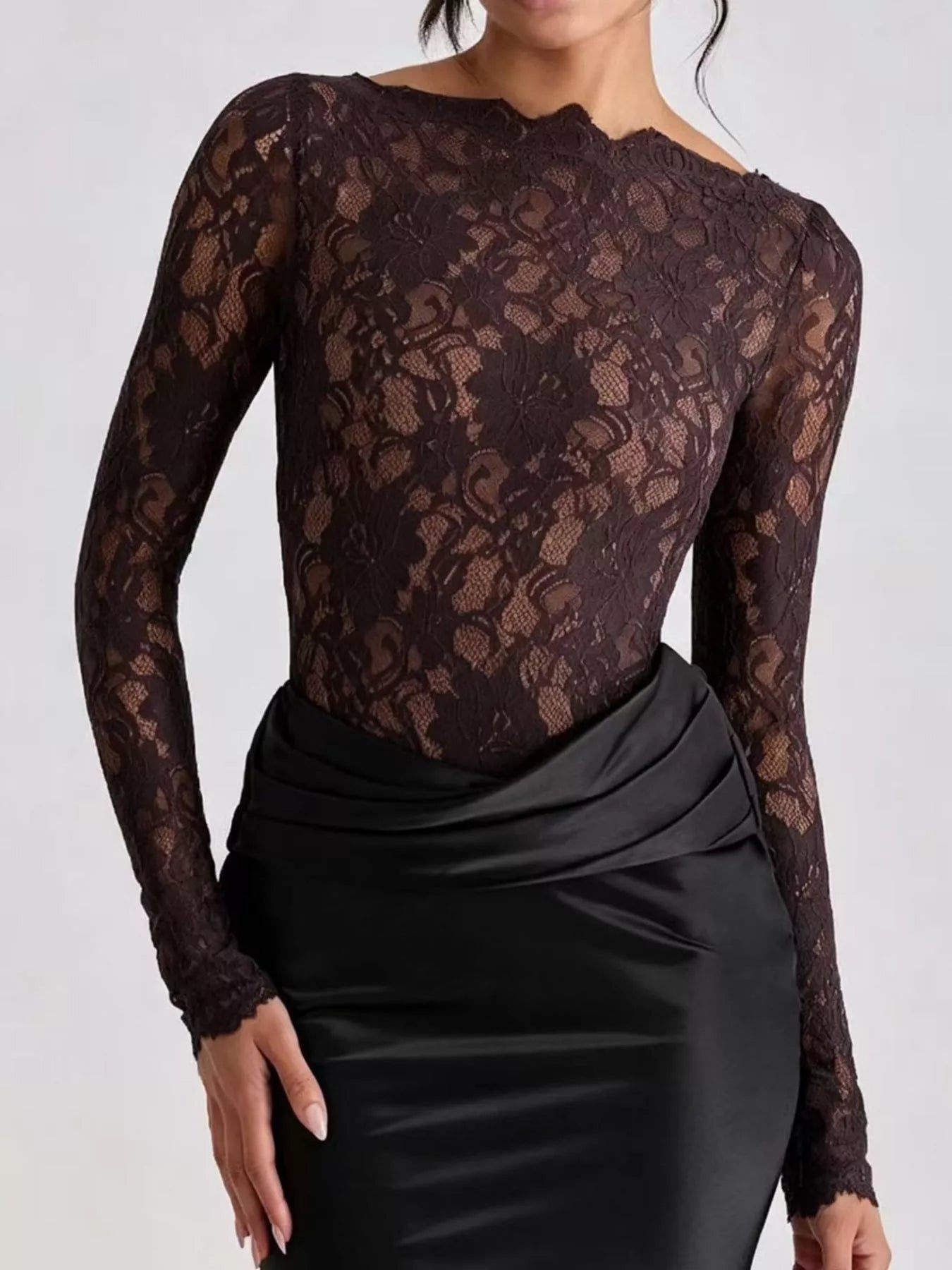 Close view of black lace bodice and draped black satin waist on maxi dress