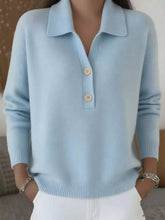 Light blue collared long sleeve sweater with two button placket and white pants