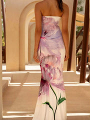 Model wearing strapless white and purple floral tube maxi dress, back view outdoors