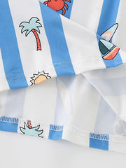Close view of hem stitching and striped beach print fabric on a children's cartoon tee