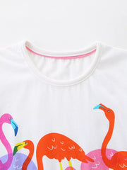 Close-up of the white round neckline with pink inner trim above the flamingo print
