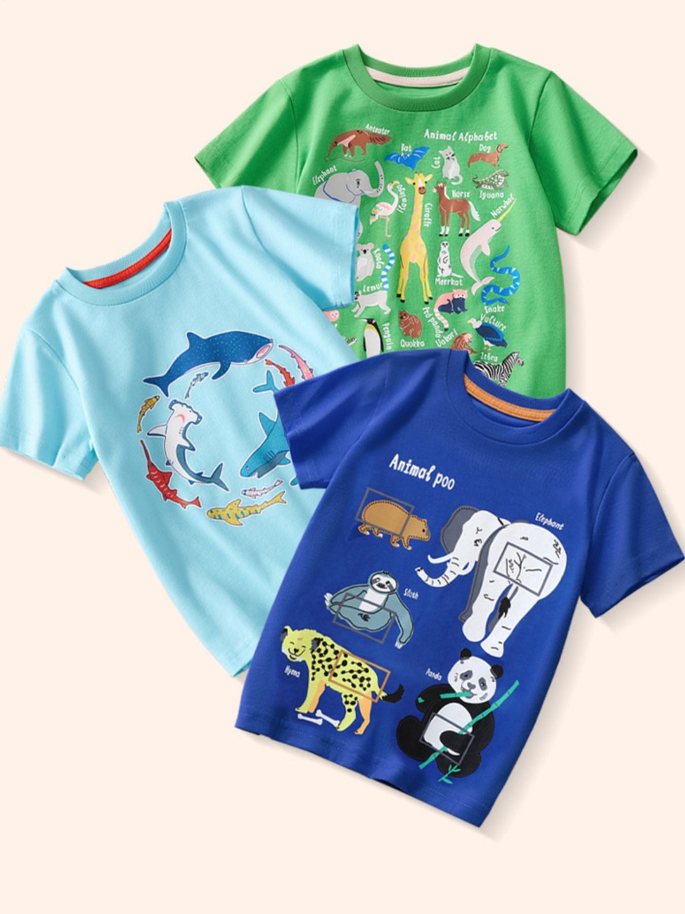 Flat lay view of three children's animal print t-shirts in green pastel blue and royal blue