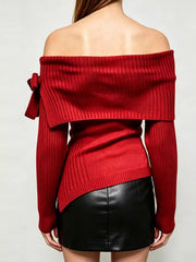 Back view of red off shoulder ribbed knit top with wide neckline and asymmetric hem