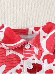 Close up of the polo collar and white buttons on a red and white children's heart print shirt