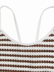 Close up of brown and white striped knit dress neckline with white straps and open back detail