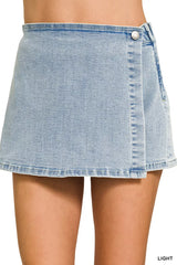 Women's light-wash denim skort with a wrap front and asymmetrical hemline.