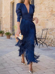 Full length view of a dark blue fringed maxi dress with a tiered fringe skirt outdoors