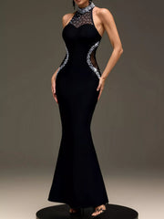 Front view of black sleeveless maxi dress with pearl trim on a round platform