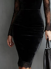 Close view of the lower skirt and lace hem of a black long sleeve velvet bodycon dress