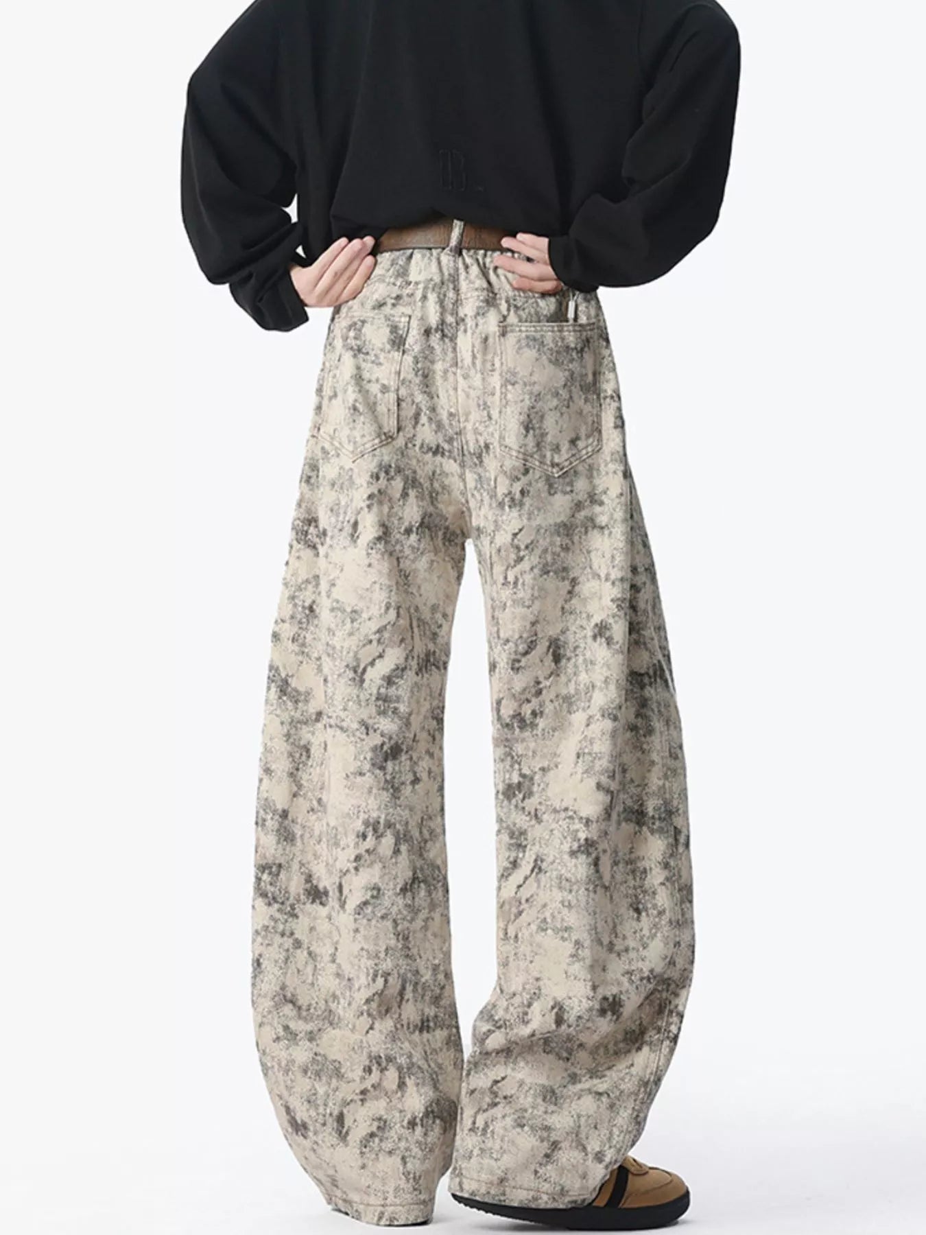 Men's washed jeans with a wide leg silhouette.