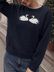 Front view of a navy sweater with facing white swans and dropped shoulder sleeves