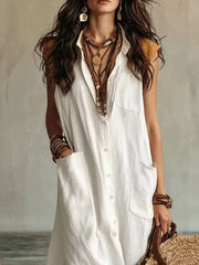 Close view of white sleeveless button down linen maxi dress showing buttons and large pockets