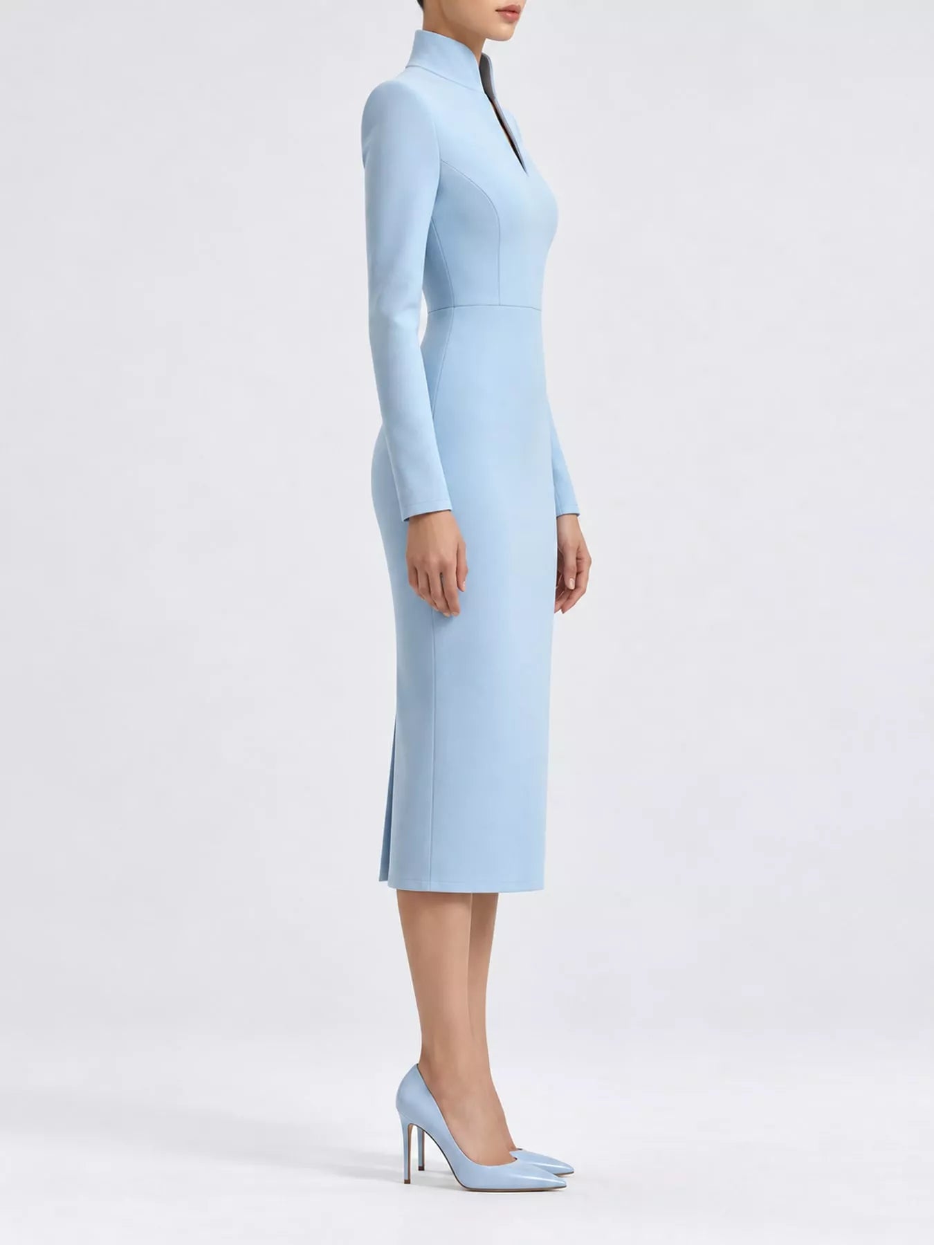 Sky blue stand collar long sleeve midi dress in side profile showing hem slit and heels