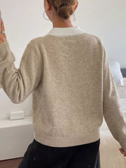 On-model back view of the solid beige argyle sweater with a white polo collar