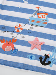 Close-up of the boat, crab, starfish and anchor prints on a blue and white striped children's T-shirt
