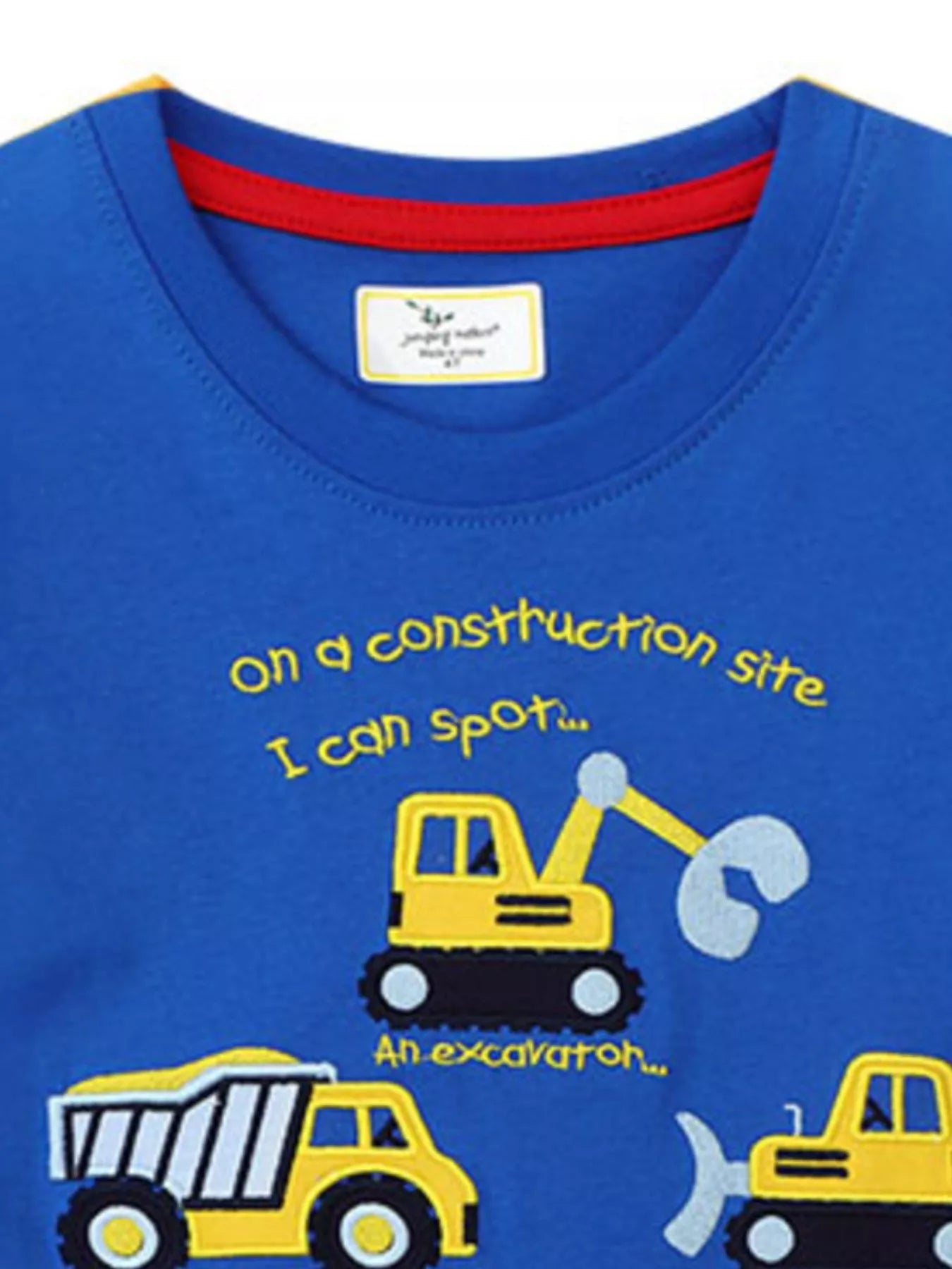 Close view of the crew neckline and excavator graphic on a blue children's t shirt