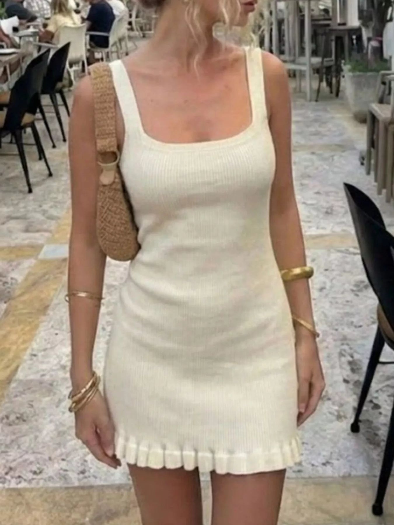 Front view of a cream ribbed knit square neck dress with wide straps and ruffled hem.