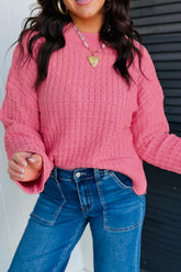 Hot pink textured knit sweater with round neck and dropped shoulders on model