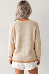 Back view of a plain beige long sleeve sweater with orange trim at the neckline and hem
