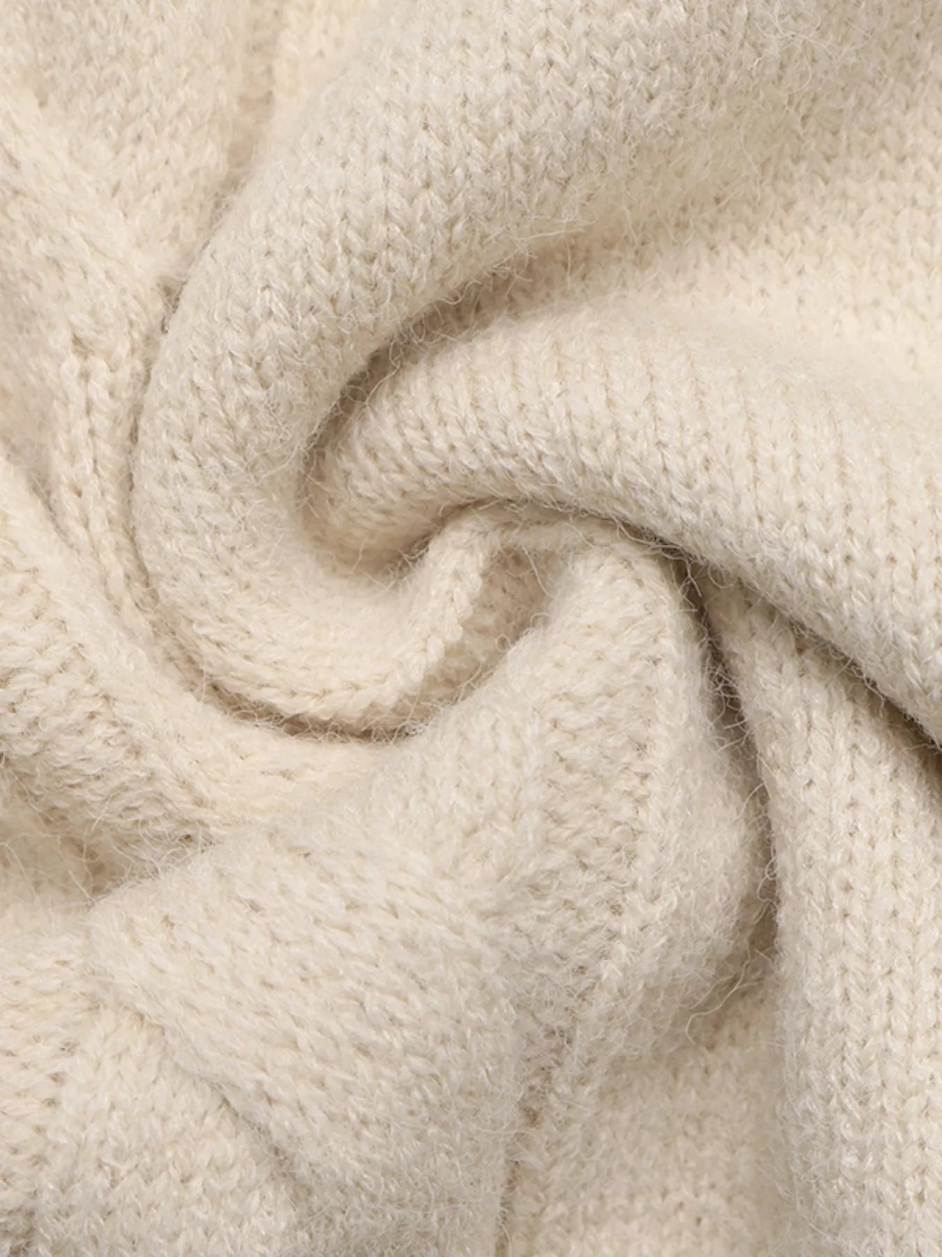 Close up texture detail of beige cable knit fabric on the sweater dress