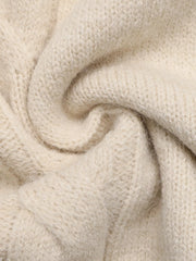 Close up texture detail of beige cable knit fabric on the sweater dress