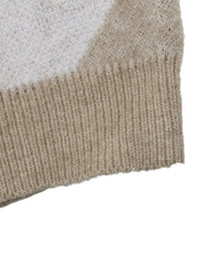 Close-up of the beige ribbed hem on the argyle polo sweater