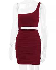 Front view of burgundy one shoulder cutout ruched bodycon mini dress on a clear mannequin